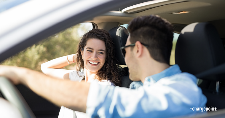 Happy couple in an EV