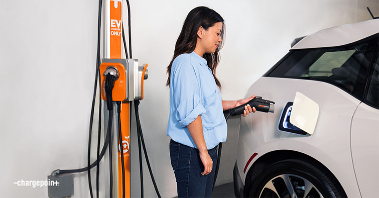 Person using a ChargePoint station to charge an EV