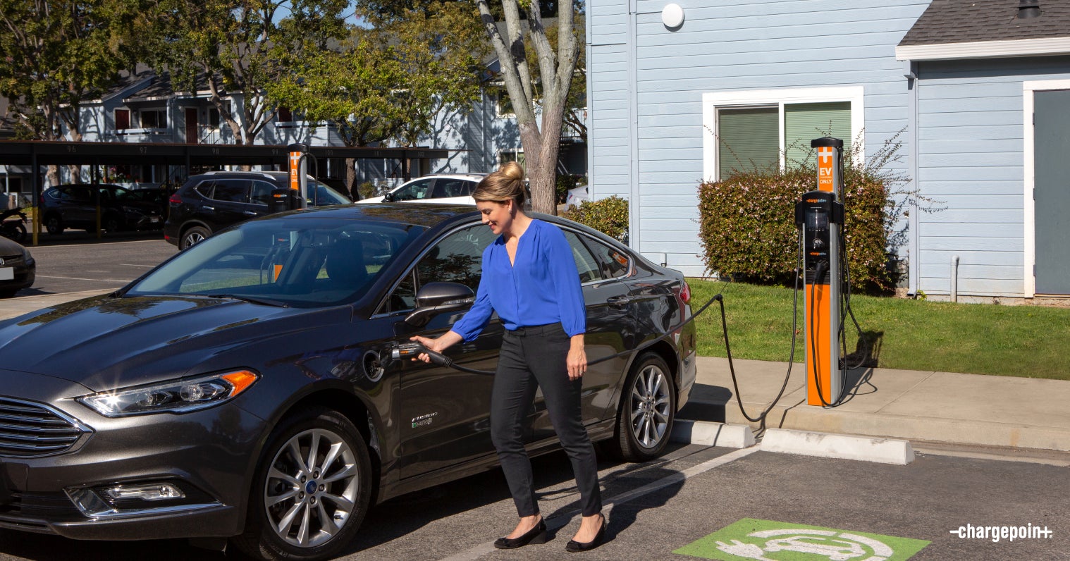 Woman Charging EV at Multifamily Property