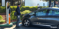 Employee charging an EV at work