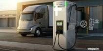 Electric truck beside a fast-charging station outside a modern facility, with icons indicating cooling technology.