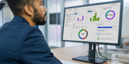 Person in front of a computer using ChargePoint Platform