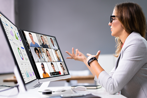 Person in front of computer on a conference call 