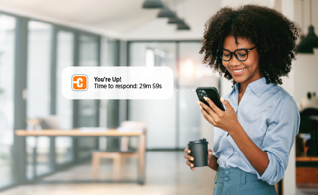 Person checking their phone and a message bubble showing waitlist message