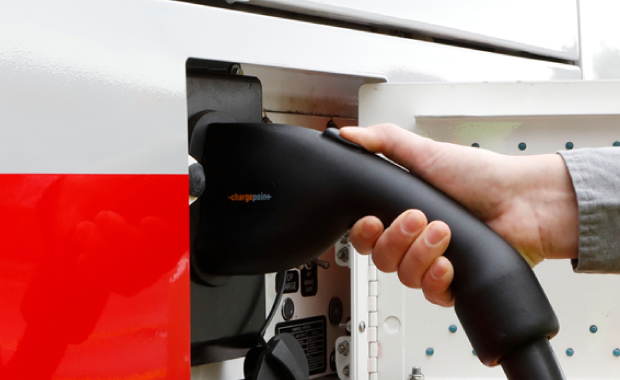 Hand using a charging plug