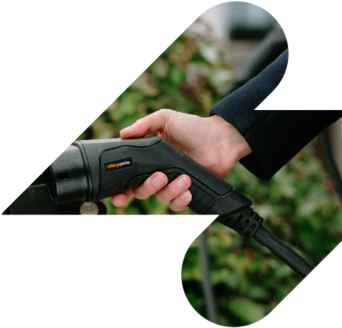 Hand holding a charging plug in a lightning bolt shape