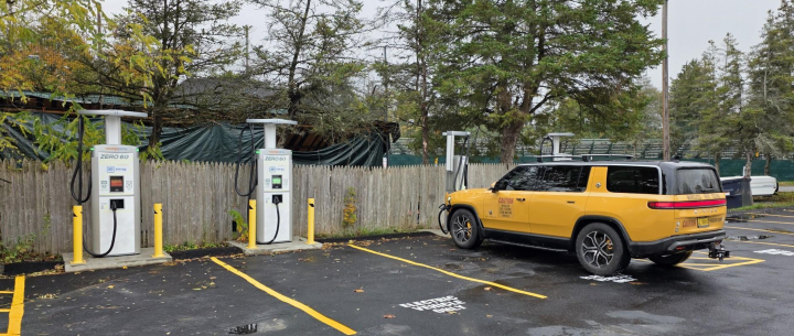 A yellow car parked next to a charging station