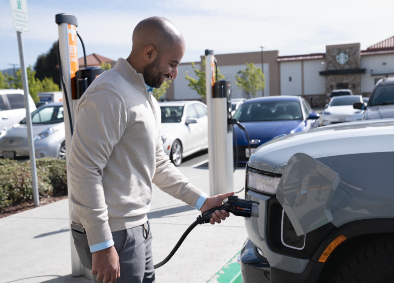 Person charging their car Person charging their car